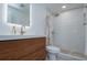 Modern bathroom with a wood vanity, gold fixtures, and glass enclosed shower at 2870 Rampart Cir, Clearwater, FL 33761