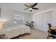 Bedroom with ceiling fan, carpet, closet, and window for natural light, plus desk and drums at 2870 Rampart Cir, Clearwater, FL 33761