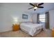 Comfortable bedroom features a ceiling fan, neutral walls, carpet, and windows providing natural light at 2870 Rampart Cir, Clearwater, FL 33761