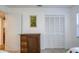 Bedroom featuring closet, dresser, neutral paint, carpet and a sunflower painting at 2870 Rampart Cir, Clearwater, FL 33761