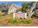 Chateaux Woods community sign surrounded by manicured landscaping and greenery at 2870 Rampart Cir, Clearwater, FL 33761