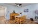 Bright dining area with natural light, wood flooring, a charming piano, and a ceiling fan at 2870 Rampart Cir, Clearwater, FL 33761