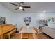 Cozy dining area featuring a ceiling fan, wooden furniture, and a decorative painting on the wall at 2870 Rampart Cir, Clearwater, FL 33761