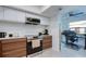 Modern kitchen with stainless steel appliances and sleek cabinets flows to an adjacent office space at 2870 Rampart Cir, Clearwater, FL 33761