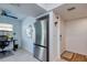 Open kitchen with stainless steel refrigerator adjacent to an office space at 2870 Rampart Cir, Clearwater, FL 33761