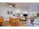 Open concept living space with wood floors, dining area, modern lighting, and comfortable seating at 2870 Rampart Cir, Clearwater, FL 33761