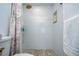 Modern shower with bronze fixtures, tiled walls, and recessed shelf at 2870 Rampart Cir, Clearwater, FL 33761