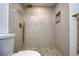 Walk-in shower featuring bronze fixtures and a decorative pebble floor at 2870 Rampart Cir, Clearwater, FL 33761