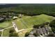 Expansive aerial view of a golf course community, showcasing lush green fairways, residential homes, and surrounding woodlands at 3350 Stonebridge Trl, Valrico, FL 33596