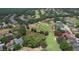 Expansive aerial shot showcasing the home's location on a golf course within a lush, green neighborhood at 3350 Stonebridge Trl, Valrico, FL 33596