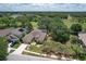 An aerial shot showcasing the property near the golf course, lush greenery, and a serene lake at 3350 Stonebridge Trl, Valrico, FL 33596