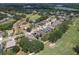 A scenic aerial view of a neighborhood featuring homes bordering a golf course, complete with ponds and green spaces at 3350 Stonebridge Trl, Valrico, FL 33596