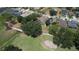 Aerial view of home with pool and lush landscaping, adjacent to a golf course and mature trees at 3350 Stonebridge Trl, Valrico, FL 33596