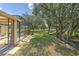 Landscaped backyard featuring a covered patio, verdant lawn and access to a tranquil stream at 3350 Stonebridge Trl, Valrico, FL 33596