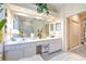 Bathroom with a dual sink vanity, large mirror, and recessed lighting at 3350 Stonebridge Trl, Valrico, FL 33596