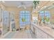 Bright bathroom boasts a large window, dual sinks, vanity and a glass shower at 3350 Stonebridge Trl, Valrico, FL 33596