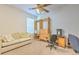 Comfortable carpeted bedroom featuring a ceiling fan and natural light at 3350 Stonebridge Trl, Valrico, FL 33596