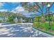 Elegant club entrance showcasing stone accents, covered entryway, and lush landscaping for a welcoming arrival experience at 3350 Stonebridge Trl, Valrico, FL 33596
