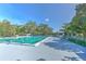 A serene community pool area featuring clear blue water, lounge chairs, and a 'no diving' sign, surrounded by lush trees at 3350 Stonebridge Trl, Valrico, FL 33596