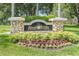 A well-maintained sign for River Hills Country Club surrounded by colorful flowerbeds and lush greenery at 3350 Stonebridge Trl, Valrico, FL 33596