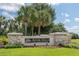 The River Hills Golf and Country Club community entrance sign is surrounded by lush greenery and palm trees at 3350 Stonebridge Trl, Valrico, FL 33596