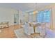 Elegant dining room with a chandelier, draped windows, and a formal table setting perfect for entertaining guests at 3350 Stonebridge Trl, Valrico, FL 33596
