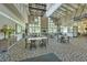 Spacious dining room with high ceilings, stone fireplace, and large windows providing natural light and picturesque views at 3350 Stonebridge Trl, Valrico, FL 33596