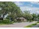 Community entrance featuring a guard house, landscaped grounds, and well-maintained roadways, enhancing security and appeal at 3350 Stonebridge Trl, Valrico, FL 33596