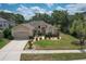 Charming single-story home featuring a meticulously landscaped front yard and a two-car garage at 3350 Stonebridge Trl, Valrico, FL 33596