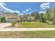 Single-story home featuring a well-maintained lawn, manicured bushes, and a convenient two-car garage at 3350 Stonebridge Trl, Valrico, FL 33596