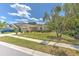 Inviting single-story home featuring a manicured lawn, complemented by lush landscaping and a convenient two-car garage at 3350 Stonebridge Trl, Valrico, FL 33596