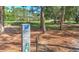 Scenic golf course view with marker post and well-maintained green, framed by trees and a path at 3350 Stonebridge Trl, Valrico, FL 33596