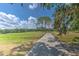 Picturesque golf course view showing the bridge to the course, blue sky, and tree line at 3350 Stonebridge Trl, Valrico, FL 33596