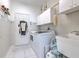 Well-equipped laundry room with modern washer and dryer, storage cabinets, and a utility sink at 3350 Stonebridge Trl, Valrico, FL 33596