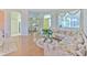 Comfortable living room with wood floors, a large sectional sofa, and views into other rooms through arched doorways at 3350 Stonebridge Trl, Valrico, FL 33596