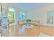 Cozy living room with wood flooring, arched doorways, comfortable seating, and natural light from the large windows at 3350 Stonebridge Trl, Valrico, FL 33596