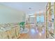 Open-concept living space with wood flooring, comfortable seating, and dining area under a chandelier at 3350 Stonebridge Trl, Valrico, FL 33596