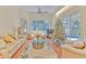 Sunlit living room featuring hardwood floors, vaulted ceilings, and a view of the outdoor pool area at 3350 Stonebridge Trl, Valrico, FL 33596