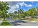 Scenic street view of the River Hills community entrance, showcasing lush trees and well-maintained landscaping at 3350 Stonebridge Trl, Valrico, FL 33596