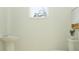 A bathroom features a pedestal sink, a toilet, and a framed painting at 3444 Lapis Lake Dr, Zephyrhills, FL 33541