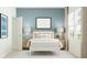 Comfortable bedroom with a soft color palette, racecar themed art, and bright natural light at 3444 Lapis Lake Dr, Zephyrhills, FL 33541