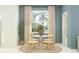 Cozy dining area featuring a round table with seating for four, a large window with light filtering blinds at 3444 Lapis Lake Dr, Zephyrhills, FL 33541