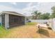 Spacious backyard with a screened patio and hammock, perfect for outdoor enjoyment at 34447 Blue Ash Ct, Wesley Chapel, FL 33545