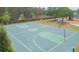 Outdoor recreational basketball court with playground and picnic tables in the background at 34447 Blue Ash Ct, Wesley Chapel, FL 33545