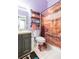 Unique bathroom design with industrial shelving, modern fixtures, and playful shower curtain at 34447 Blue Ash Ct, Wesley Chapel, FL 33545