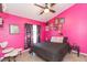 Vibrant bedroom with a ceiling fan and a cozy black patterned bedspread, ready for relaxation at 34447 Blue Ash Ct, Wesley Chapel, FL 33545