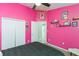 A brightly colored bedroom with carpet, white closet doors and a doorway to the en suite bathroom at 34447 Blue Ash Ct, Wesley Chapel, FL 33545