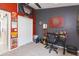 Office space with decorated red and grey walls, a window and a closet at 34447 Blue Ash Ct, Wesley Chapel, FL 33545