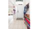 Bright foyer with tile flooring, coat rack and bench, offering a welcoming entrance to the home at 34447 Blue Ash Ct, Wesley Chapel, FL 33545