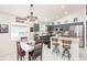 Open kitchen with stainless steel appliances, blue cabinets, breakfast bar, and adjacent dining area at 34447 Blue Ash Ct, Wesley Chapel, FL 33545